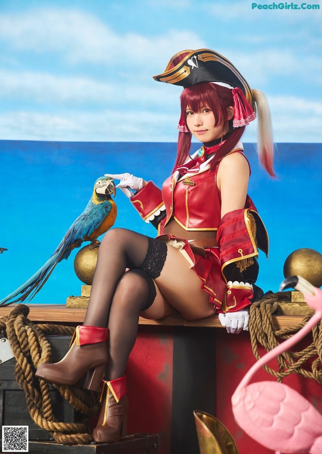 A woman dressed as a pirate sitting on top of a boat.
