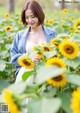 A woman standing in a field of sunflowers.